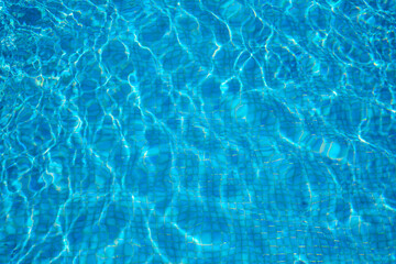 Surface of blue swimming pool. Texture of water background in swimming pool with tile