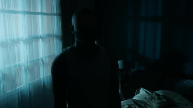 African American man in pink sleep mask sleepwalking at night, his Caucasiam wife waking him up and they smile at each other going back to sleep