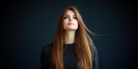 Fototapeta premium A young woman gazes thoughtfully into the distance.