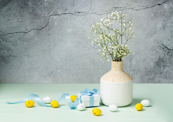 Ester decor, concept, eggs and grift box on table.Floral design card, nobody.