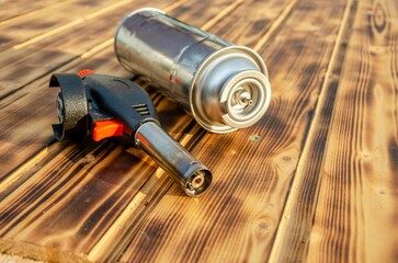 Metal gas burner on the wooden background.