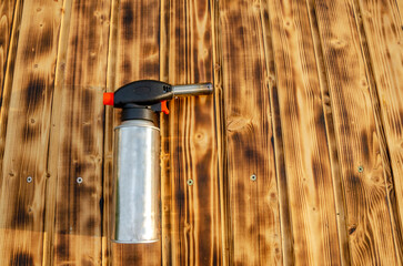 Metal gas burner on the wooden background.