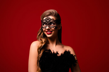 Photo of pretty girl wearing aristocrat costume mask for halloween party looking on red color background