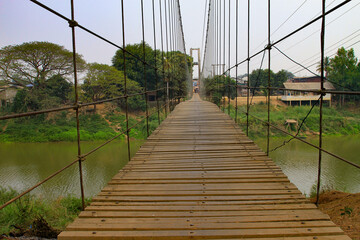 Wooden Suspension Bridge over Yom River in Thailand