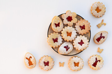 Linzer cookies filled with strawberry and apricot jam, copy space for text. Easter baking