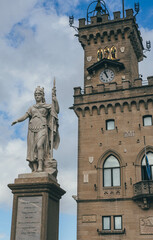 the tower of the townhall with statue of woman victory in san marino city main square