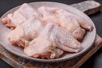 Raw chicken wings with salt, spices and herbs