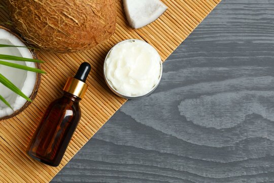 Bottle of coconut oil on wooden background