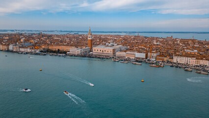 Venetian Panorama: A stunning aerial view captures the beauty of Venice, showcasing its iconic architecture, winding waterways, and vibrant cityscape under a soft, inviting sky.