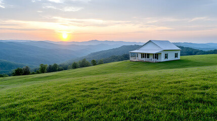 Obraz premium Mountain sunset view, white house on grassy hill