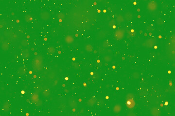 Golden particles sparkle on a green background creating a magical atmosphere