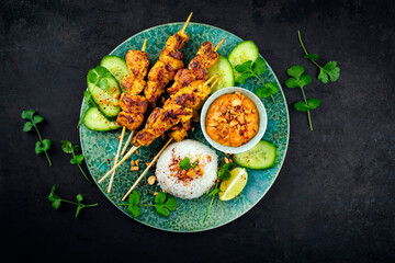 Sate Ayam- Grilled chicken satay sate skewers with peanut dipping spicy sauce, steamed rice and...