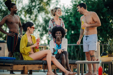 Friends enjoying drinks and conversation at a rooftop party