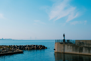 Lighthouse and Øresund Bridge Under a Clear Blue Sky
