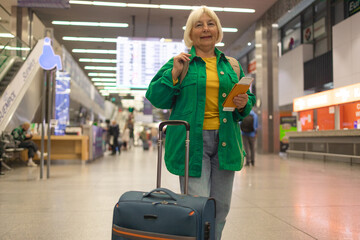 Traveler tourist happy smiling joyful fun mature elderly senior lady woman 55 years old with hand...