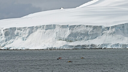 Submersibles from an expedition cruise ship await on the surface off the coast of Antarctica.