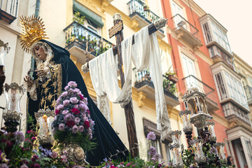 Holy Week procession in Malaga with the Virgin Mary and the cross, Spain
