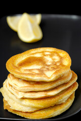 A stack of pancakes with a lemon slice on side. Shrove Tuesday. pancake day