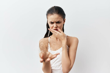 Woman expressing disgust with a neutral background, highlighting emotions and body language Her...