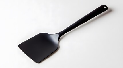 黒い調理用フライ返しのシンプルなクローズアップ