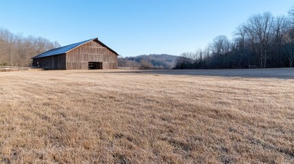 Obraz premium Rustic Barn in a Winter Meadow