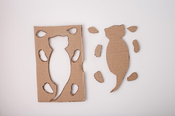 a piece of cardboard with outlines drawn on it. cut out next to it on the right side. a template or...