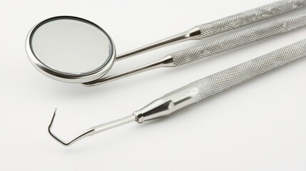 Close up of dental mirror probe with stainless steel tools on a white background