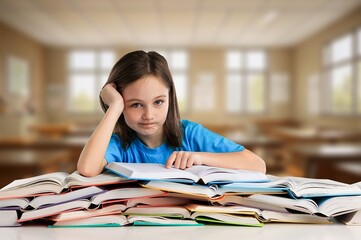 Tired sad small student portrait in classroom for education