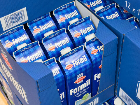 Boxes of formil uht milk cartons in blue packaging