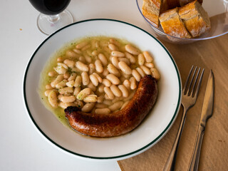 Top view of Catalan stewed beans with butifarra sausage