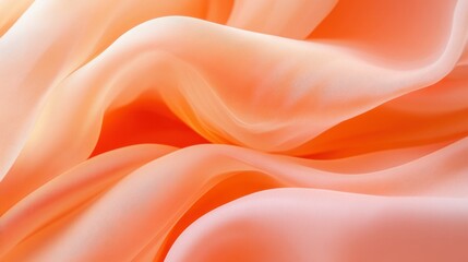 Obraz premium A close-up of soft, flowing fabric in a warm peach hue, highlighting its smooth texture and elegance.