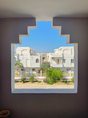 View from the window of traditional Arab streets, small houses and palm trees. Travel to middle east countries
