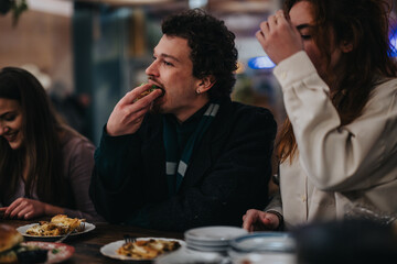 A group of friends relish delicious food in a warm and inviting restaurant atmosphere.