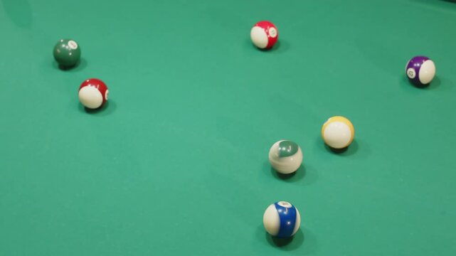 No people top view shot of two billiard balls spinning on baize table among other balls