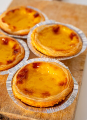 Portugal's traditional sweet dessert Pastel de nata egg custard tart pastry in cup close up