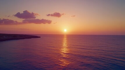 Obraz premium Stunning sunset at Ayia Napa sea caves, where the sky glows in shades of orange, pink, and purple over the crystal-clear Mediterranean.
