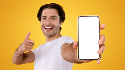 Check This Website. Portrait of smiling male holding smart phone with white blank screen in hand,...