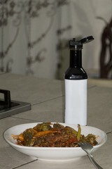 Plate of Stir-Fry Vegetables With Sauce and Vinegar Bottle in the Kitchen