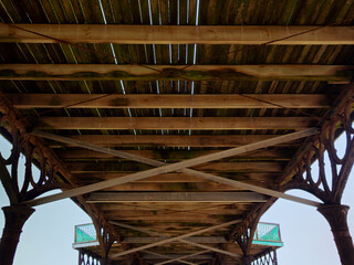 view of the underside of the Edwardian pier at Lytham St Annes on the sea showing the wood and metal structure