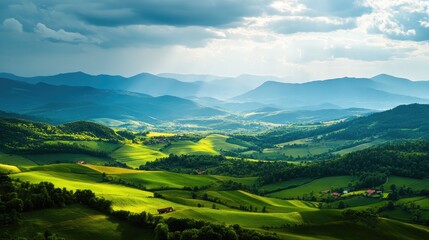 Obraz premium A lush green valley between high mountains, rolling fields, and bright open sky for text placement.