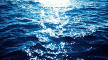 A refreshing sea landscape with bright blue water, sunlight casting beautiful highlights on the surface.