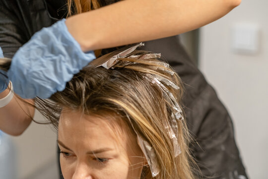 Hair coloring process in a salon with foil application during a clients appointment