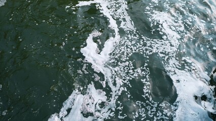 A stunning closeup view of a foamy water surface beautifully showcasing natures inherent beauty and fluid motion