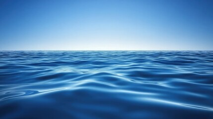 Obraz premium A tranquil sea with gentle waves rolling onto the shore, deep blue water meeting the clear sky, ample copy space.