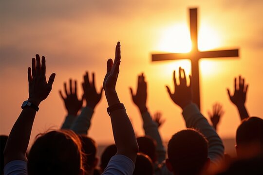 A Diverse Group of Adults Worshiping at Sunset, Raising Hands in Praise Before a Cross Silhouetted Against the Beautiful Orange and Yellow Sky