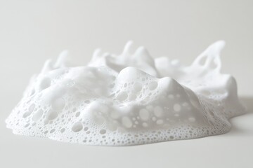 Fluffy white soap foam with bubble textures on light surface