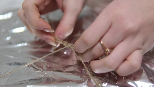 tie string rope on foil open gift open pizza delivery unpacking Woman, bow or hands with box for delivery, supply chain or packaging order at warehouse. Small business, strings tie or owner 