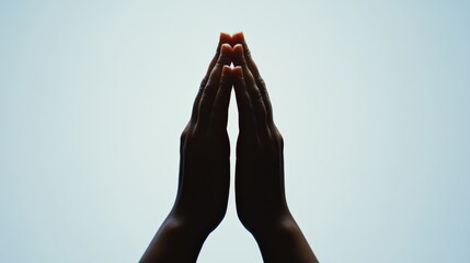 Hands in Prayer Pose Silhouette Against Light Background