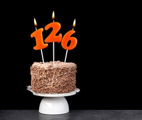 Birthday cake with number 126 candle - Anniversary card on a black background.