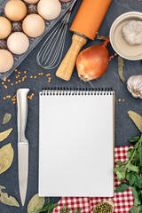 Cooking ingredients with blank notebook. Open recipe book with herbs and spices.